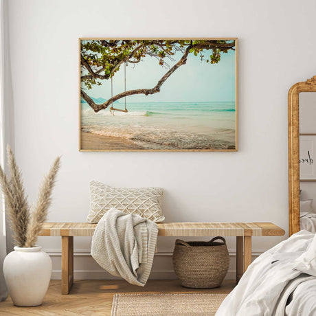 Coastal photography wall art print with a beach swing hanging from a tree above gentle ocean waves and sandy shore