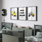 Three yellow construction prints featuring a dump truck, tracked digger and Build Your Dreams quote with road-style letters.