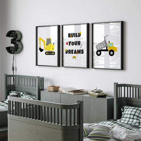Three yellow construction prints featuring a dump truck, tracked digger and Build Your Dreams quote with road-style letters.