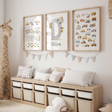 Three construction themed wall art prints displayed together in a warm neutral toddler bedroom