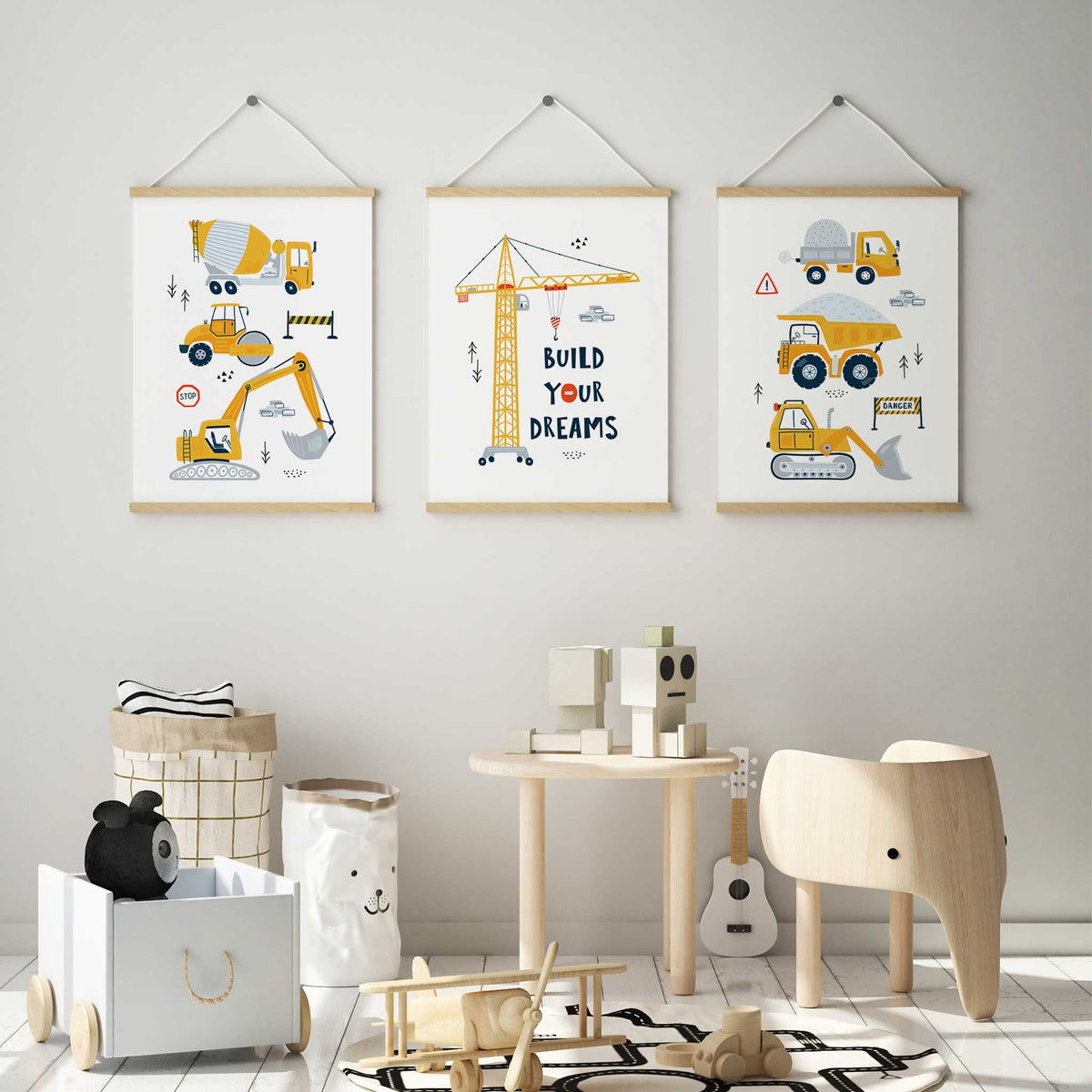 Three yellow construction vehicle prints featuring a cement mixer, dump trucks, diggers and a Build Your Dreams crane.
