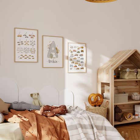Set of three construction wall art prints with alphabet numbers and personalised name displayed in a boys bedroom