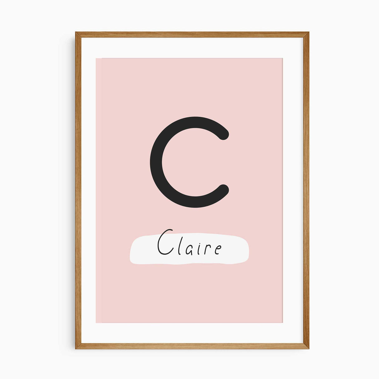 Personalised girls dinosaur name print featuring a large initial and child’s name in blush and coral tones