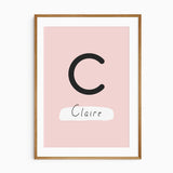 Personalised girls dinosaur name print featuring a large initial and child’s name in blush and coral tones