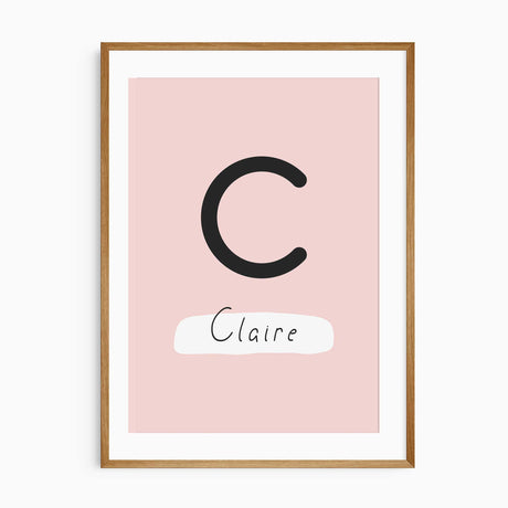 Personalised girls dinosaur name print featuring a large initial and child’s name in blush and coral tones