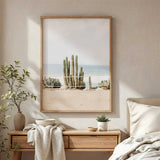 Desert ocean wall art featuring tall cactus plants near shoreline