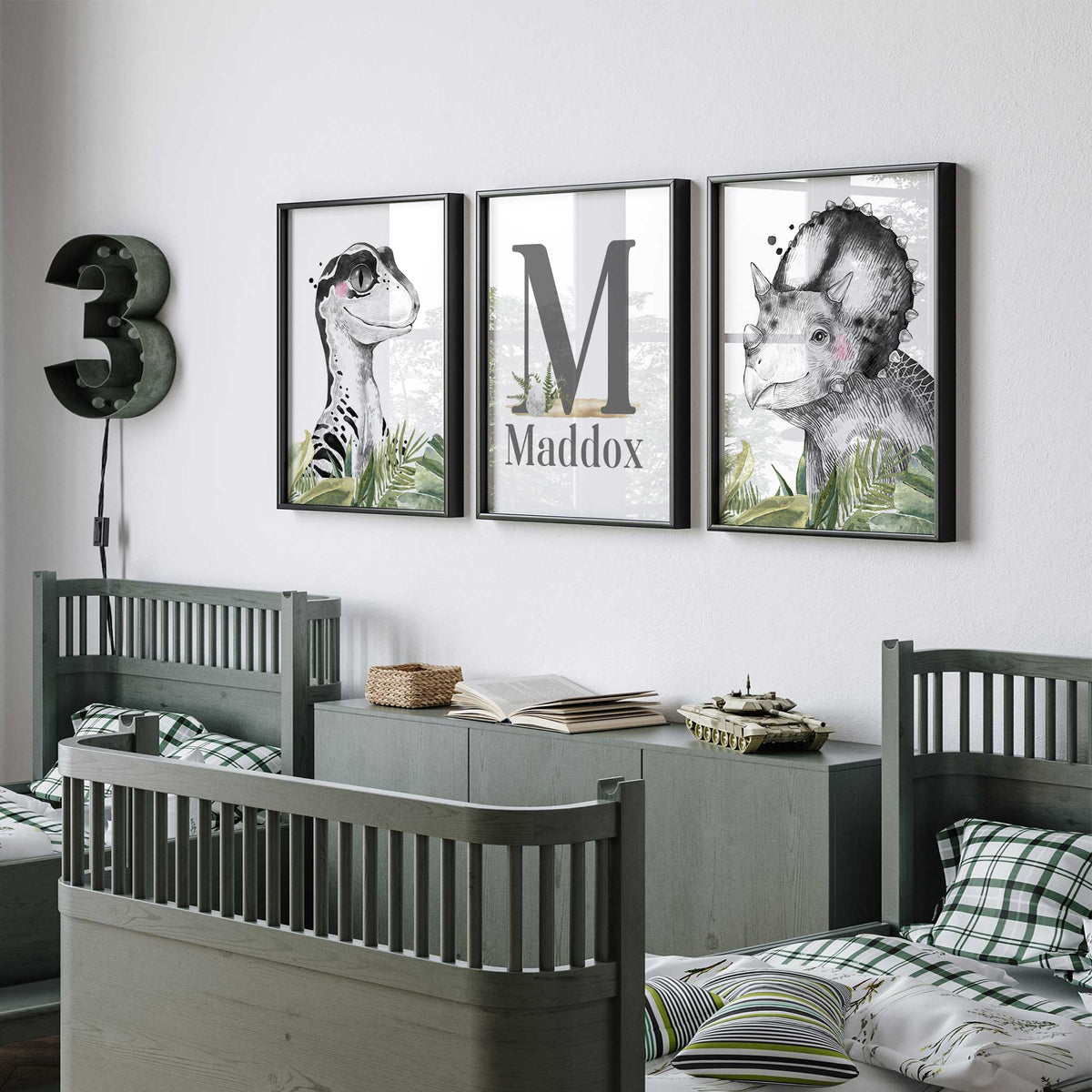 Three dinosaur bedroom prints with black and white portraits, green foliage and a personalised name and initial design.