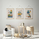 Three dinosaur construction vehicle prints in a beige and white nursery, featuring a personalised name print 