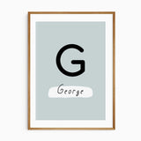 Centre dinosaur print customised with a child’s initial and name, part of a matching three-print wall art set
