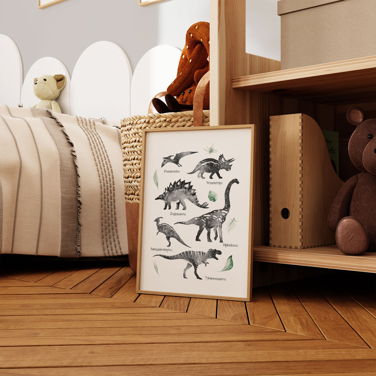 Dinosaur wall art print with labelled black and white dinosaurs and soft green leaves