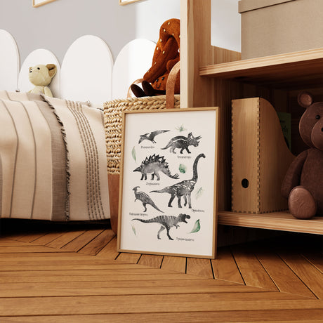 Dinosaur wall art print with labelled black and white dinosaurs and soft green leaves
