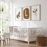Three personalised dragon nursery prints combining brown and cream baby dragons, celestial details and a name and initial design.