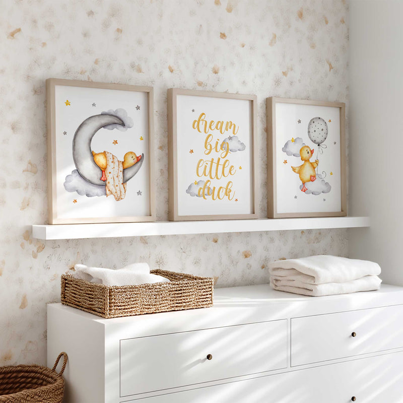Dream big little duck nursery print set in soft yellow and grey with balloon, moon, and cloud illustrations for kids bedroom wall art.