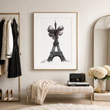 Detailed black Eiffel Tower fashion illustration decorated with a large textured grey ribbon bow on a white background.