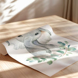 Adorable baby elephant nursery wall art print with greenery accents, perfect for safari or jungle-themed baby room décor