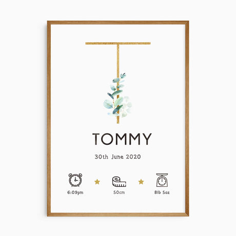 Eucalyptus baby name print with a gold-toned initial, watercolour leaves and personalised newborn birth details