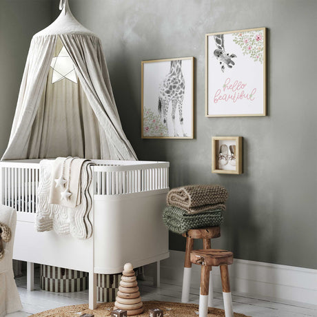 Floral giraffe nursery art set featuring two coordinated hello beautiful prints for modern baby girl bedroom walls.