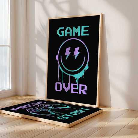 Three unframed gaming prints featuring Game Over text, controller and smiley pattern, and Press Start design