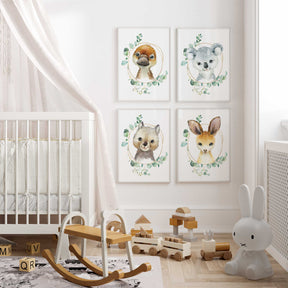 A set of four Australian animal prints, featuring illustrations of a kangaroo, koala, platypus, and wombat, for a nursery room setting.