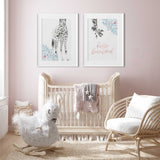 Set of two giraffe girls prints with hello beautiful text and soft floral details for coordinated nursery wall art.