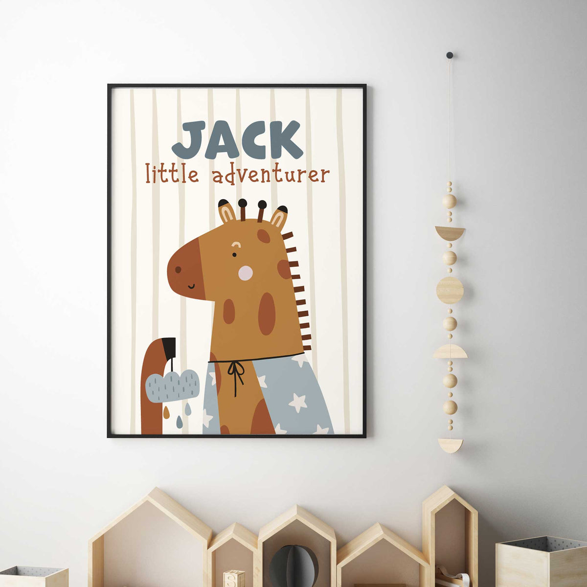Personalised giraffe print wearing a party hat with little adventurer wording on a soft striped background.