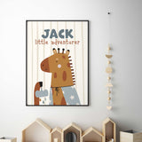Personalised giraffe print wearing a party hat with little adventurer wording on a soft striped background.