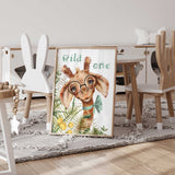 Charming kids' room decor with a quirky giraffe in glasses and a teal bowtie, surrounded by greenery and yellow florals, captioned "Wild One.