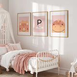 Three coordinating dinosaur prints with two pink dinosaurs and a personalised initial and name design