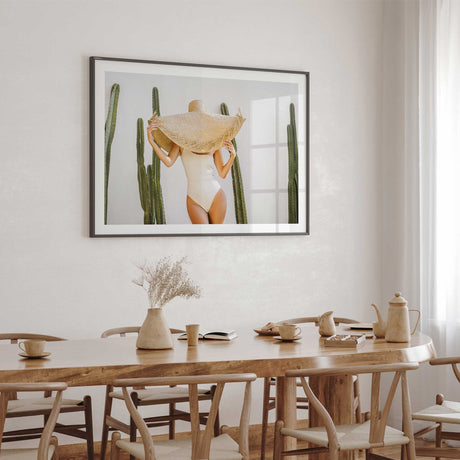 Landscape cactus wall print featuring a woman beneath an oversized straw hat.