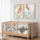 Set of two giraffe nursery prints with leafy greenery and the words Hello Little One