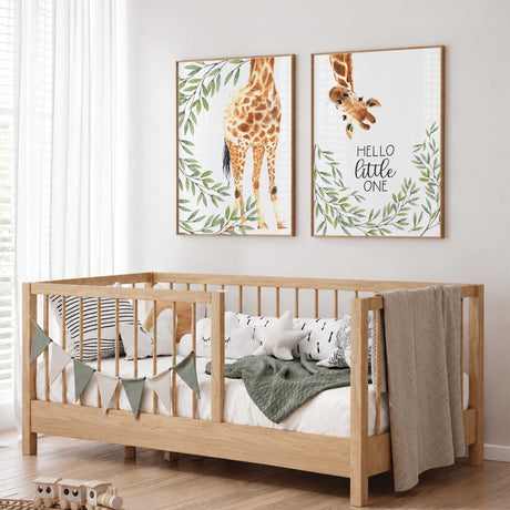 Set of two giraffe nursery prints with leafy greenery and the words Hello Little One