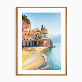 Italy coastal town wall art print featuring Amalfi Coast pastel buildings and sandy beach under blue sky
