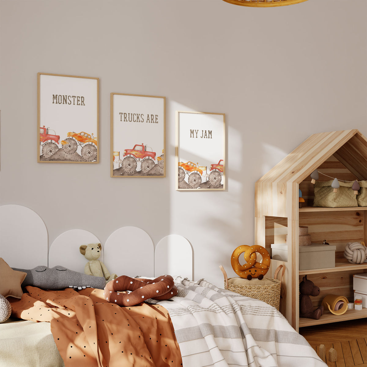 Three monster truck wall art prints showing red and orange trucks beneath Monster, Trucks Are and My Jam lettering.