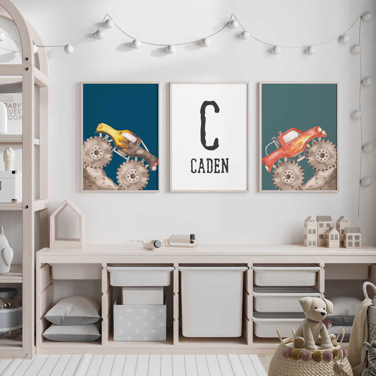 Personalised monster truck wall art with yellow and red trucks on blue and teal, plus a black initial and name.