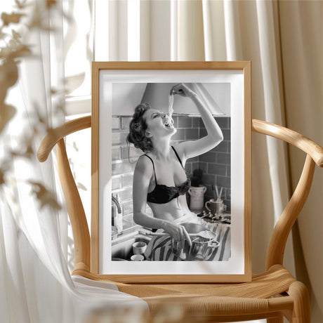 Bold black and white art print of a woman eating pasta straight from the pot – kitchen wall decor.
