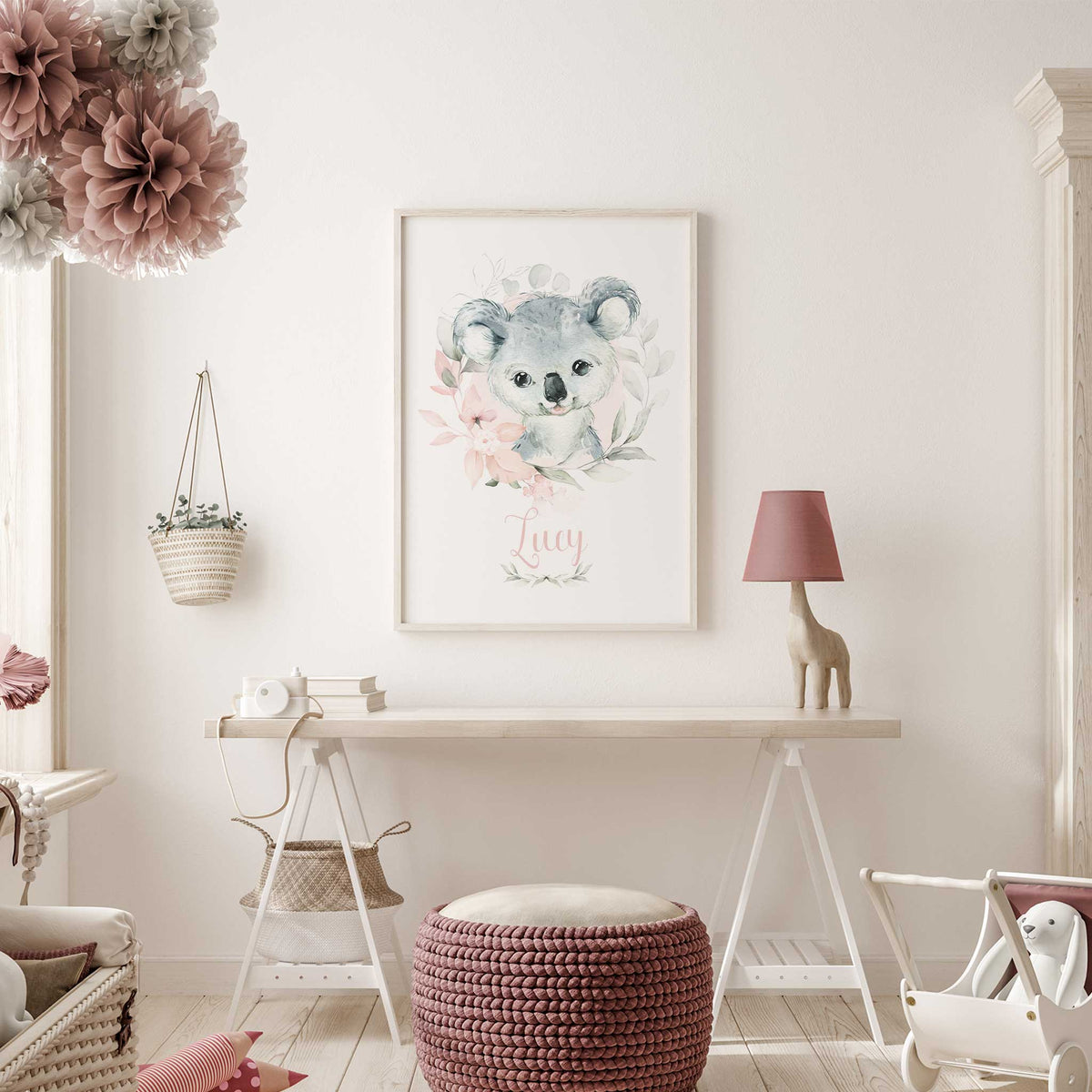 Personalised koala wall art with name in pink script, soft pink flowers and green foliage around a grey koala.