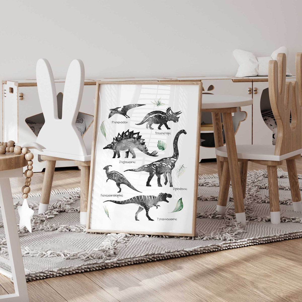 Labelled dinosaur poster with black and white prehistoric creatures, their names and soft green botanical details.