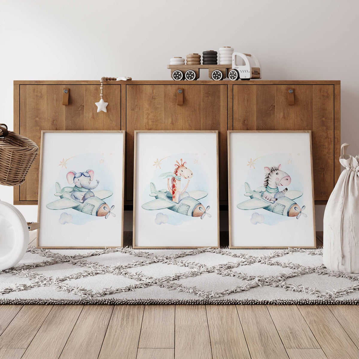Elephant, giraffe and zebra flying pale mint propeller planes in three matching prints with blue washes and beige stars.