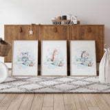 Elephant, giraffe and zebra flying pale mint propeller planes in three matching prints with blue washes and beige stars.