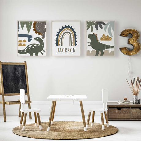 Modern set of three dinosaur prints with a custom rainbow name design in green, mustard and navy