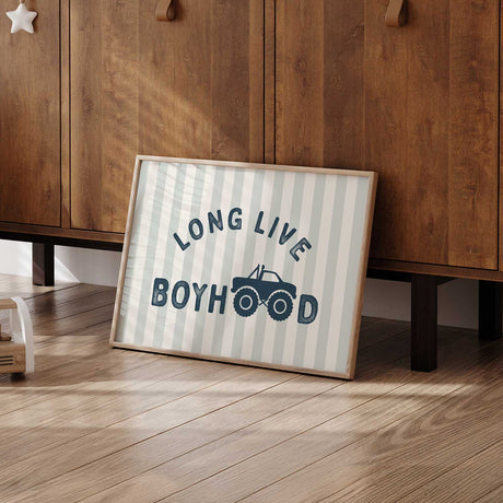 Long Live Boyhood monster truck design with navy text, oversized wheels and a pale sage and cream striped background.