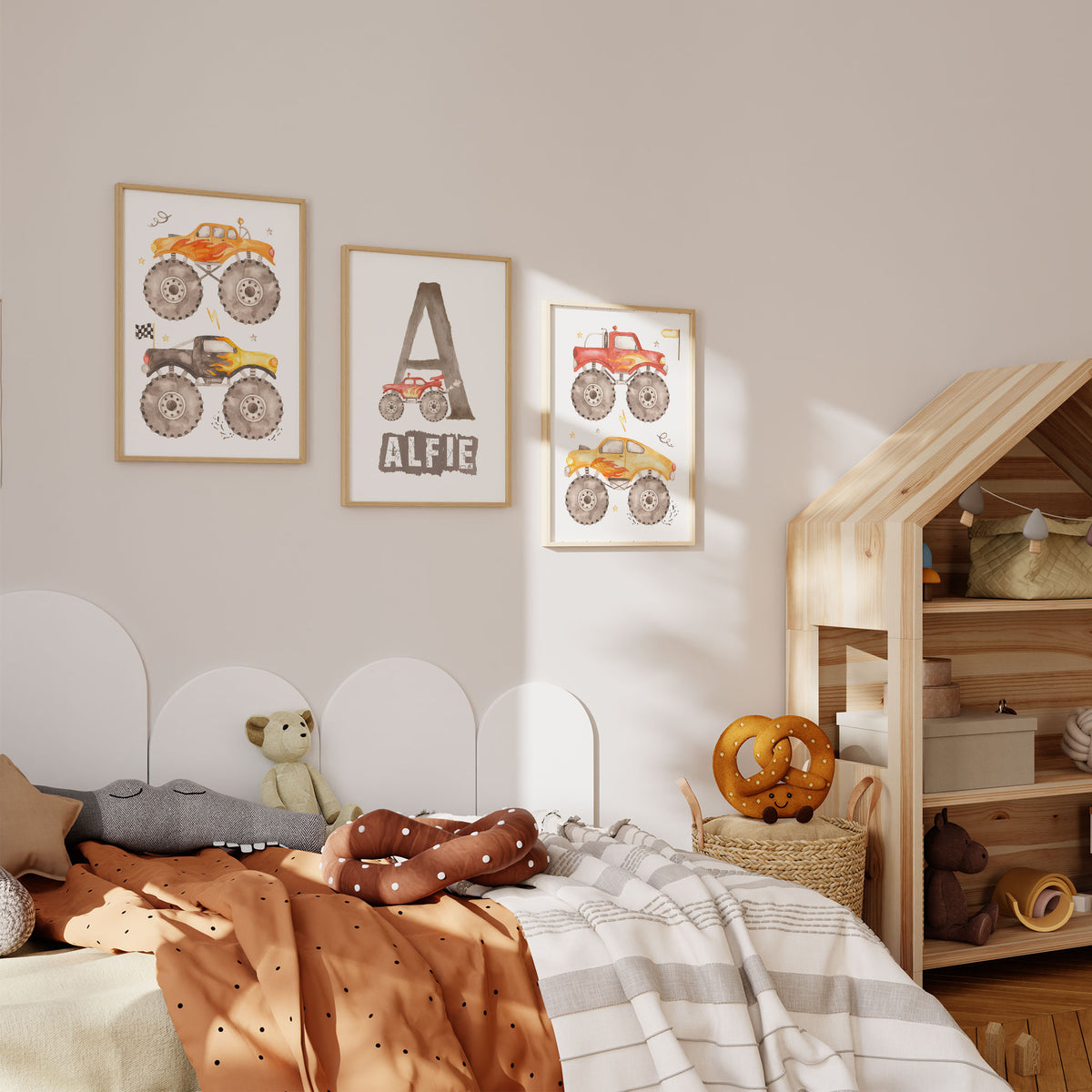 Three colourful monster truck prints displayed together in a boys bedroom with a personalised name design in the centre.