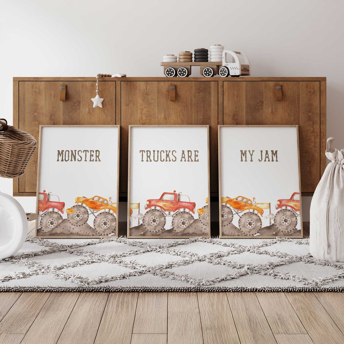 Set of three monster truck prints with red and orange trucks, dirt track details and Monster Trucks Are My Jam lettering.