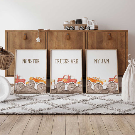 Set of three monster truck prints with red and orange trucks, dirt track details and Monster Trucks Are My Jam lettering.