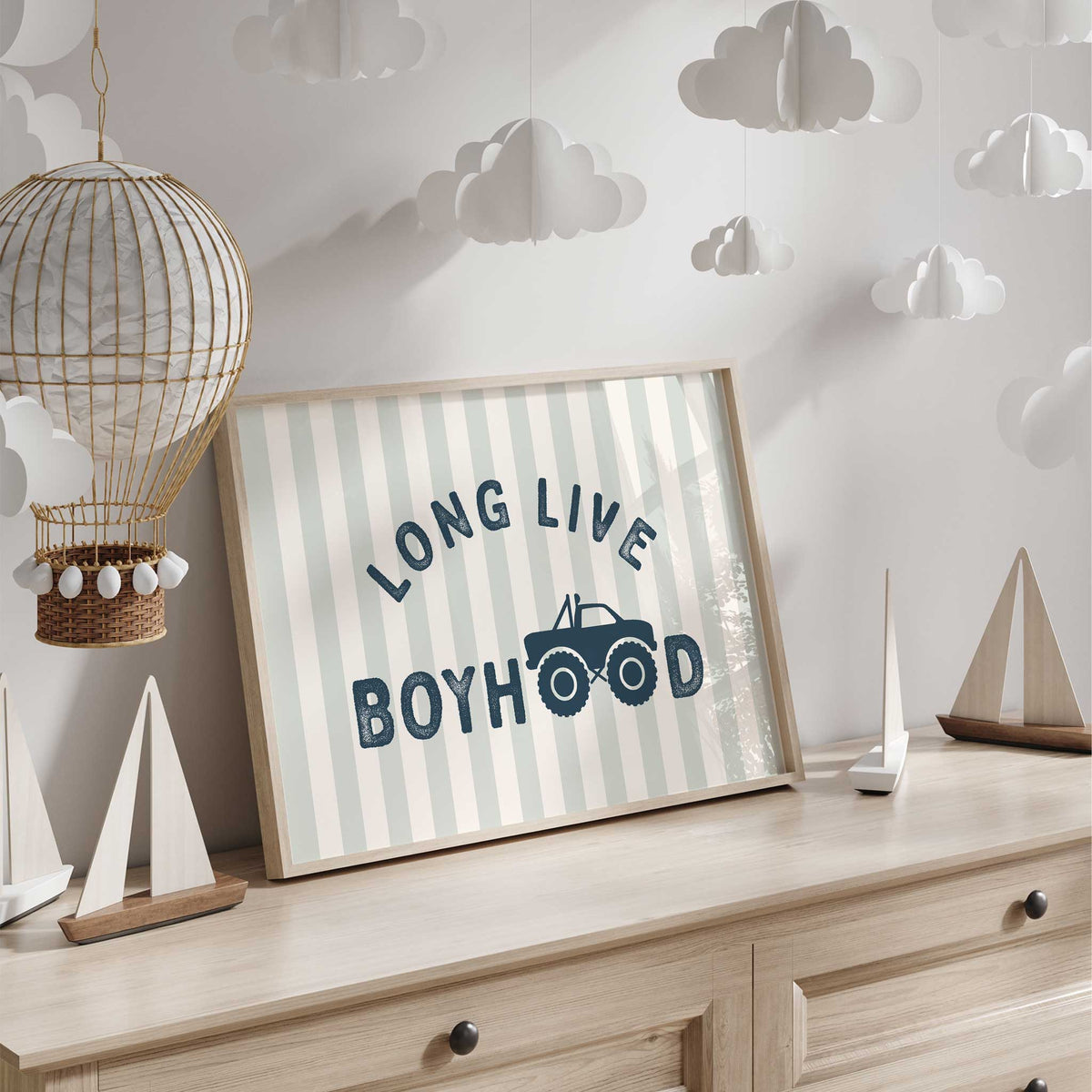 Long Live Boyhood quote print with a navy monster truck, wheel-shaped O letters and pale sage and cream vertical stripes.