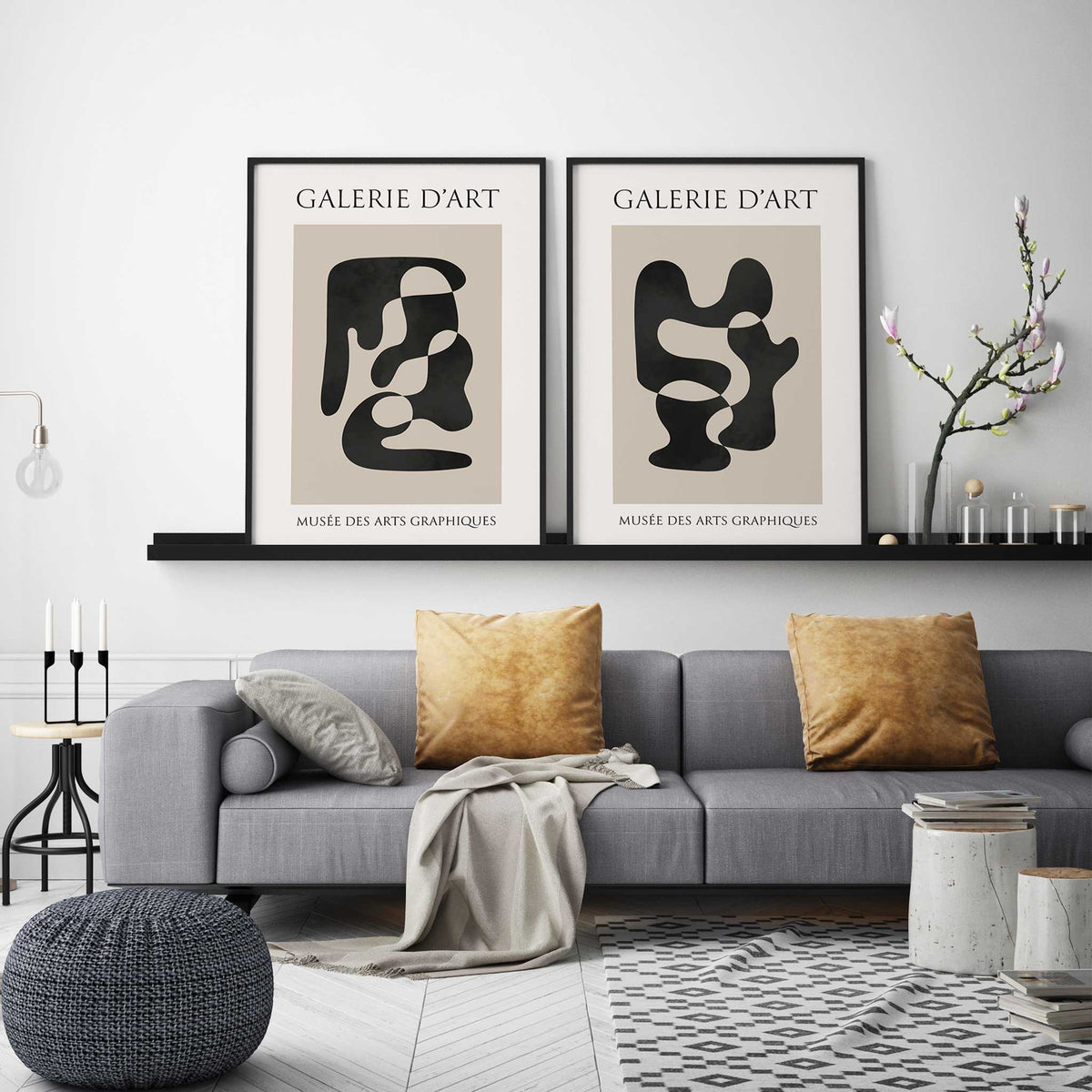 Two neutral abstract prints featuring bold black curves on warm beige panels with Galerie d’Art lettering above.