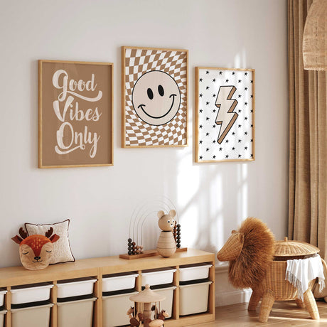 Three coordinating neutral kids prints featuring a lightning bolt, Good Vibes typography and checkerboard smiley face
