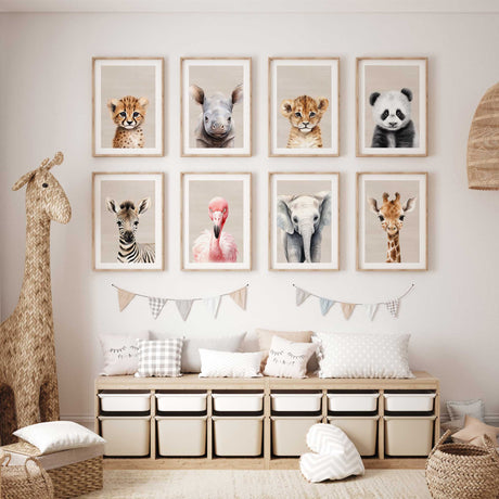 Eight safari animal nursery prints arranged as a large gallery wall with elephant giraffe zebra panda and other animals
