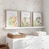 Neutral safari baby room wall art with leafy green accents