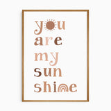 Neutral sunshine nursery wall art with playful typography for a baby room